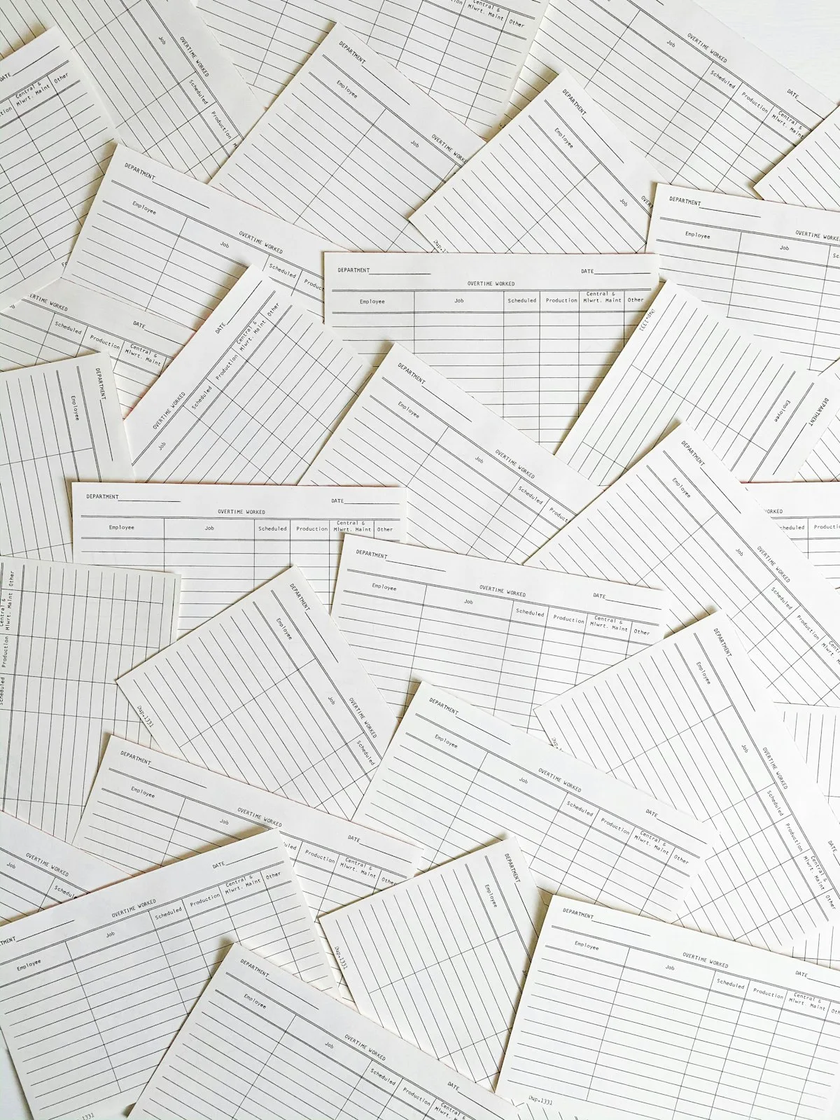 Blank ruled stock forms scattered across a table
