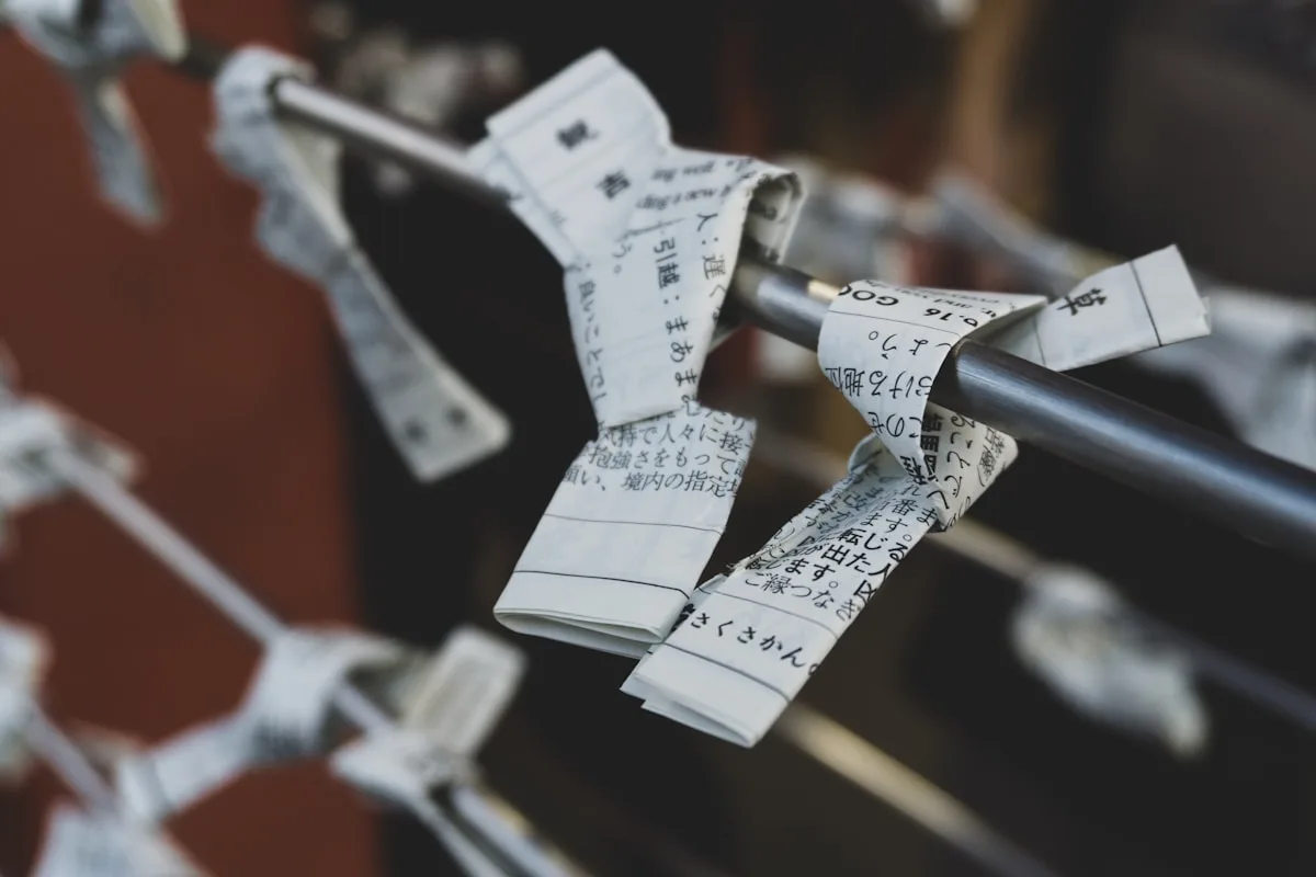 Paper order tickets clipped along a rail, waiting to be worked through