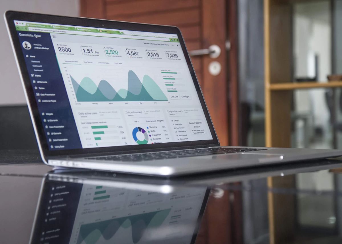 A laptop showing a simple dashboard with a few clear numbers to track